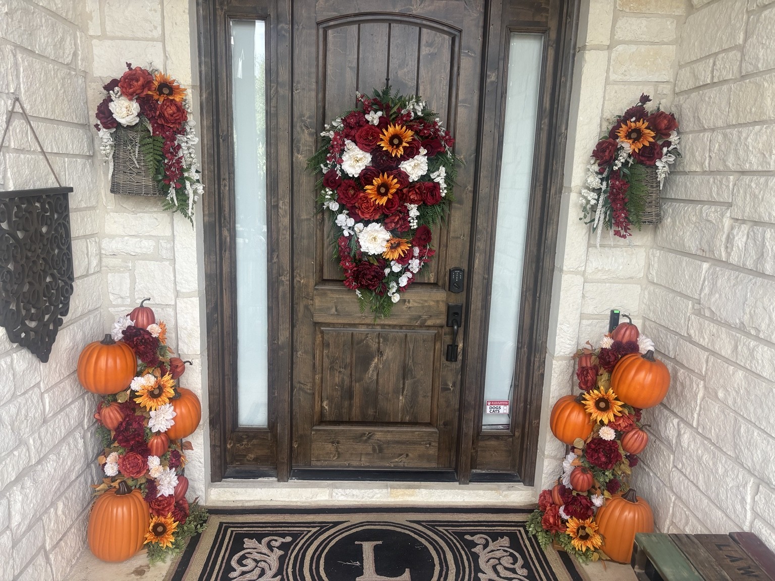 Front entry styled with autumn florals and pumpkin towers