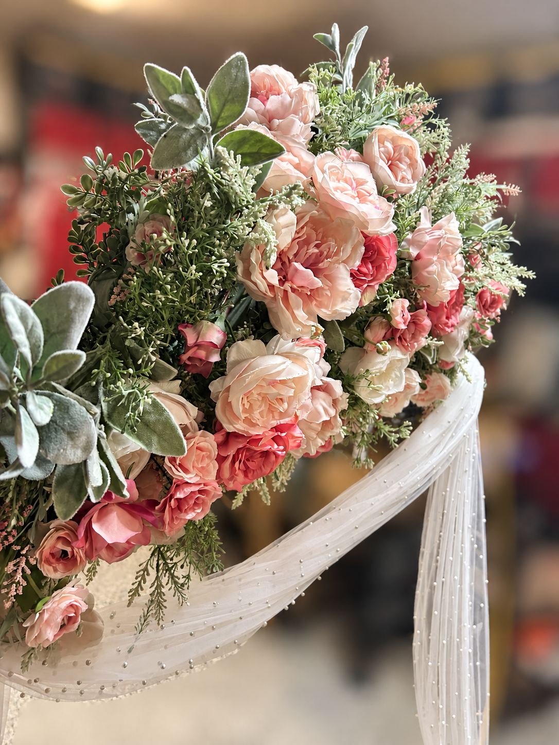 Laney’s handmade arrangement of blush, cream, and muted rose flowers
