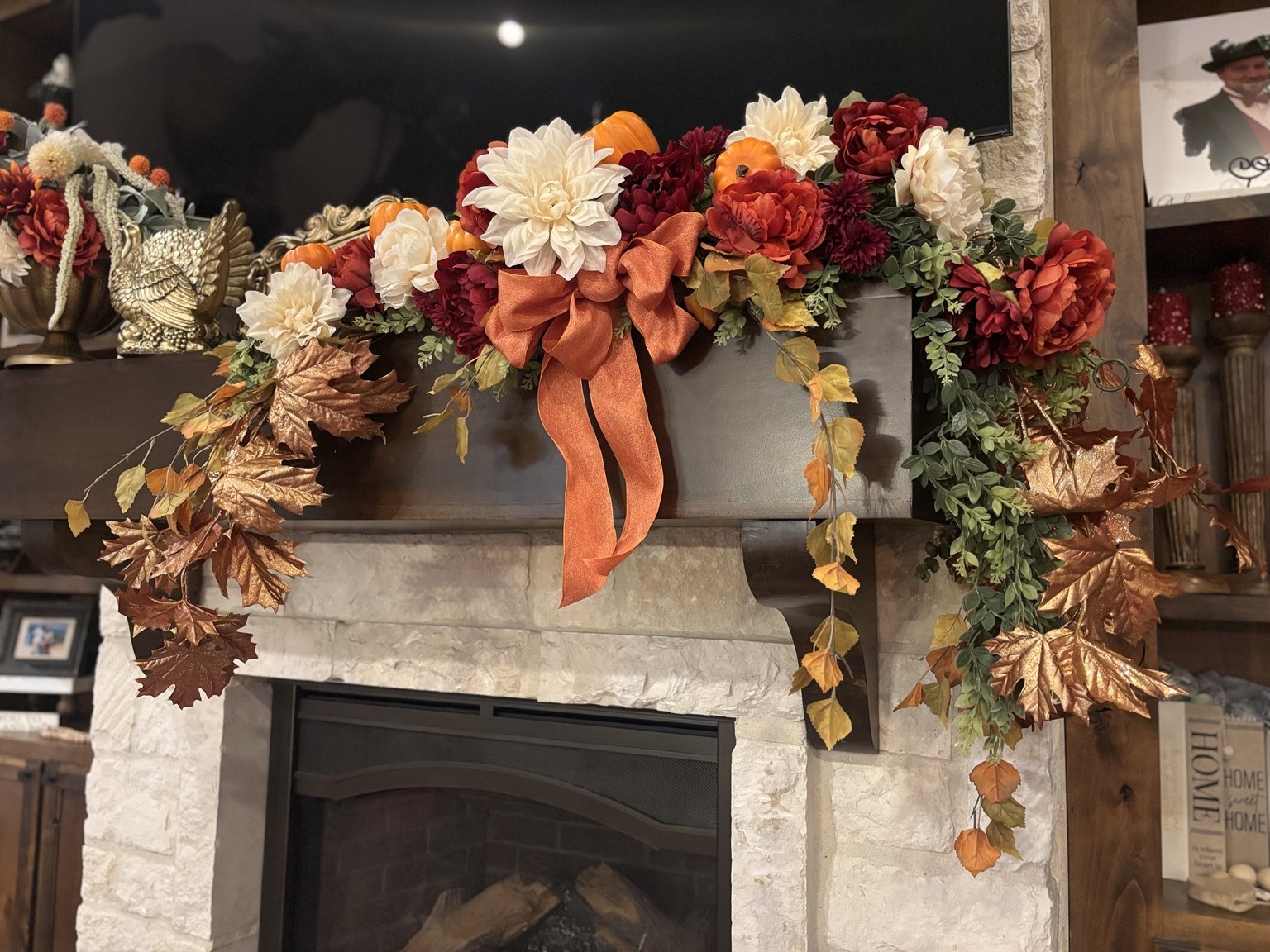 Autumn mantel garland with cream and rust flowers and orange ribbon